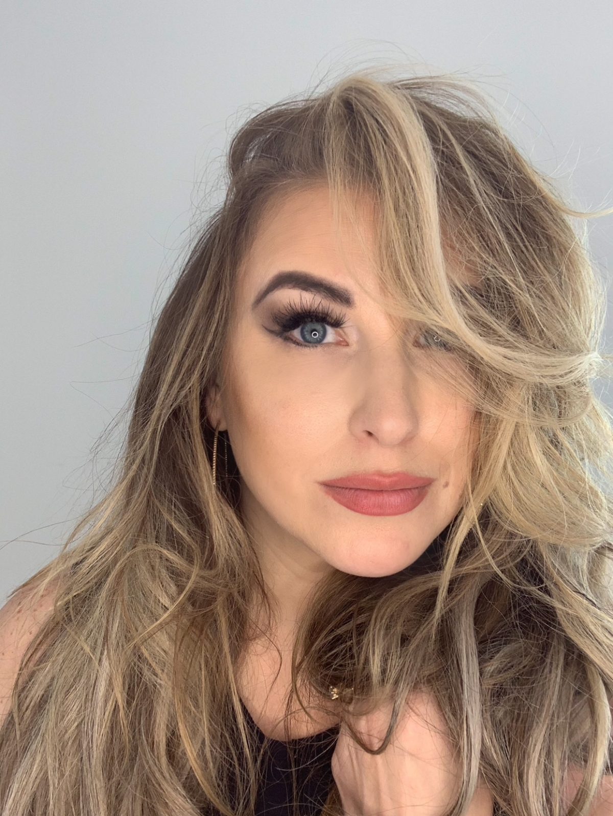 Quinn, founder and luxury colorist at Quinn Vise Hair Design in Holland, Michigan.