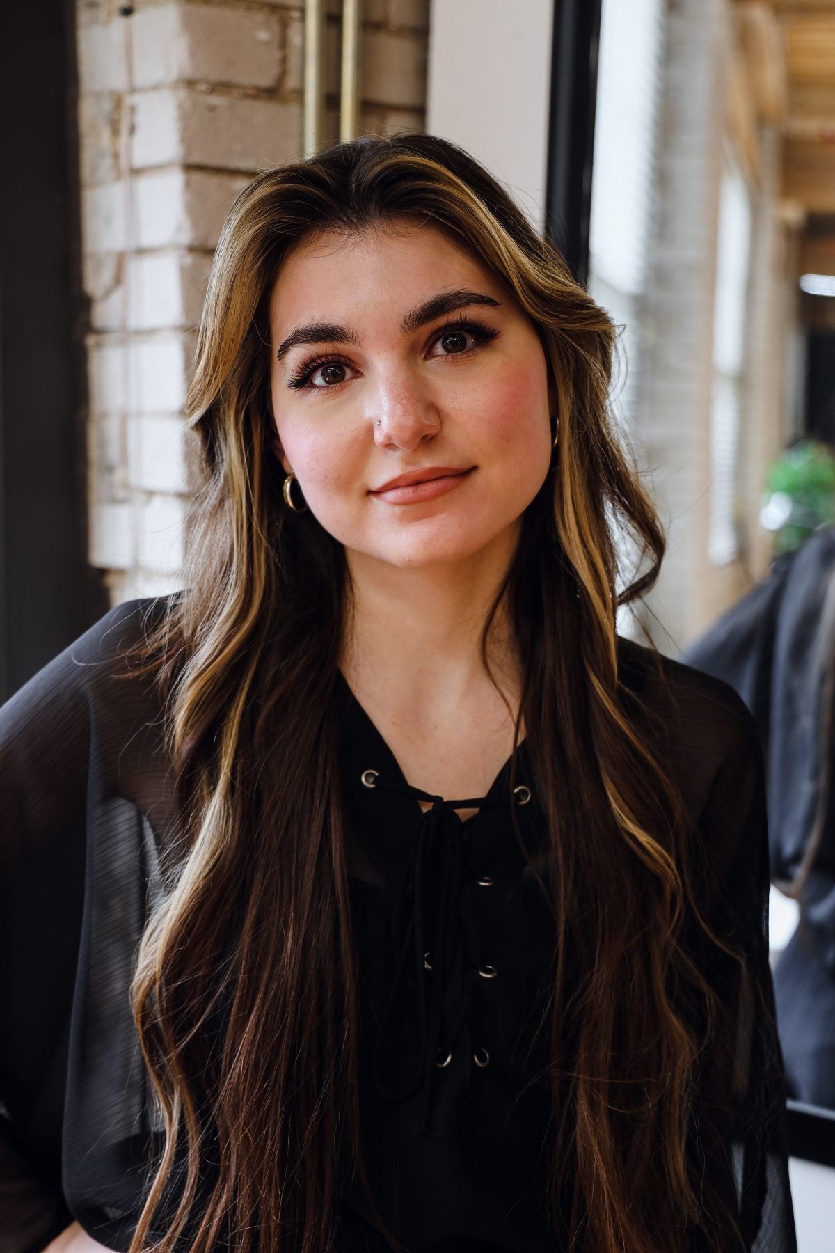 Riley, eyelash extension and brow specialist at Quinn Vise Hair Design in Holland, Michigan.